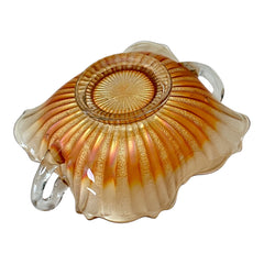 Vintage Fenton marigold carnival glass dish with stippled rays pattern, featuring a ruffled scalloped edge and clear double handles; warm amber iridescence with visible air bubbles 