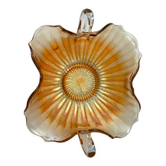 Vintage Fenton marigold carnival glass dish with stippled rays pattern, featuring a ruffled scalloped edge and clear double handles; warm amber iridescence with visible air bubbles 