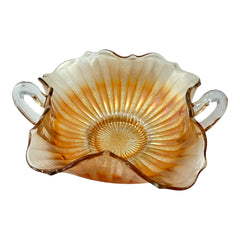 Vintage Fenton marigold carnival glass dish with stippled rays pattern, featuring a ruffled scalloped edge and clear double handles; warm amber iridescence with visible air bubbles 