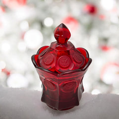 Vintage Fostoria Ruby Red Coin Glass candy dish with lid, featuring embossed coin medallions and a pointed finial; shown in rich red pressed glass with original Fostoria sticker, styled to highlight its collectible elegance and mid-century provenance.