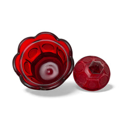 Vintage Fostoria Ruby Red Coin Glass candy dish with lid, featuring embossed coin medallions and a pointed finial; shown in rich red pressed glass with original Fostoria sticker, styled to highlight its collectible elegance and mid-century provenance.