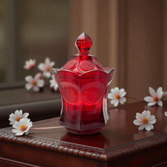 Vintage Fostoria Ruby Red Coin Glass candy dish with lid, featuring embossed coin medallions and a pointed finial; shown in rich red pressed glass with original Fostoria sticker, styled to highlight its collectible elegance and mid-century provenance.