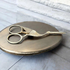 Antique French stork-shaped embroidery scissors from the late 1800s to early 1900s. Crafted with intricate details, the silver-tone finish shows charming wear, revealing darker metal and hints of faded gold-tone accents on the stork’s body when opened. A collectible and decorative piece embodying timeless craftsmanship and vintage elegance.