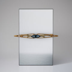 Vintage French Art Deco bar brooch with blue marquise rhinestone, gold-plated metal, and silver-tone leaf accents