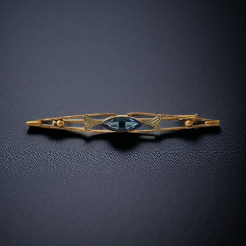Vintage French Art Deco bar brooch with blue marquise rhinestone, gold-plated metal, and silver-tone leaf accents
