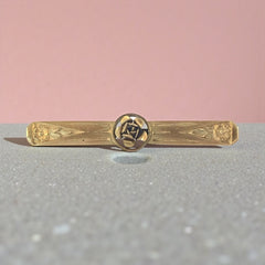Antique French Art Deco gold filled rose bar brooch, signed Oria, featuring a raised rose in a circular medallion with engraved floral motifs and a secure trombone clasp.
