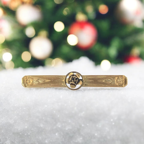 Antique French Art Deco gold filled rose bar brooch, signed Oria, featuring a raised rose in a circular medallion with engraved floral motifs and a secure trombone clasp.