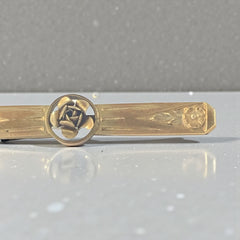 Antique French Art Deco gold filled rose bar brooch, signed Oria, featuring a raised rose in a circular medallion with engraved floral motifs and a secure trombone clasp.