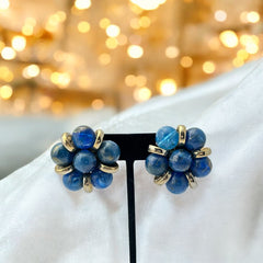 Vintage French clip-on earrings featuring marbled blue plastic beads with gold veining, arranged in a floral cluster with gold-tone rondelles, 1970s–1980s design, shown in very good condition.