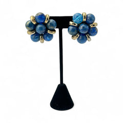 Vintage French clip-on earrings featuring marbled blue plastic beads with gold veining, arranged in a floral cluster with gold-tone rondelles, 1970s–1980s design, shown in very good condition.