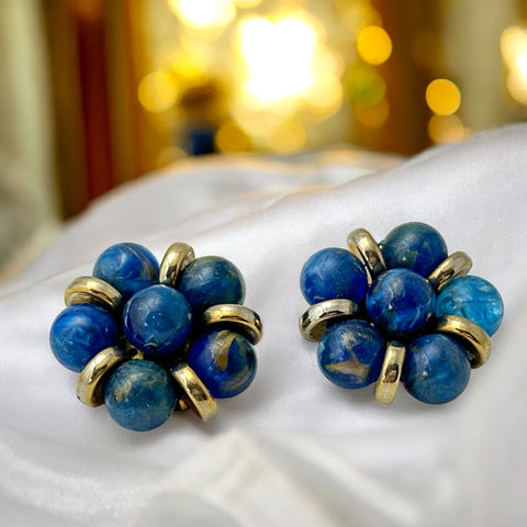 Vintage French clip-on earrings featuring marbled blue plastic beads with gold veining, arranged in a floral cluster with gold-tone rondelles, 1970s–1980s design, shown in very good condition.