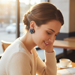 Vintage French clip-on earrings featuring marbled blue plastic beads with gold veining, arranged in a floral cluster with gold-tone rondelles, 1970s–1980s design, shown in very good condition.