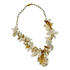 Vintage French necklace from the 1980s featuring iridescent acrylic beads, frosted and clear leaf accents, gold-tone metal details, and a central faceted pear-shaped drop with floral embellishment. Nature-inspired design in very good vintage condition
