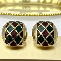 Pair of vintage French clip-on earrings with a rectangular gold-tone base, featuring a crisscross diamond lattice design filled with alternating deep red and forest green enamel; approx. 1" x ¾", late 1970s–1980s style, in very good condition with secure clips and rich color contrast.