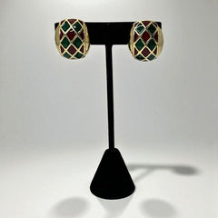 Pair of vintage French clip-on earrings with a rectangular gold-tone base, featuring a crisscross diamond lattice design filled with alternating deep red and forest green enamel; approx. 1" x ¾", late 1970s–1980s style, in very good condition with secure clips and rich color contrast.
