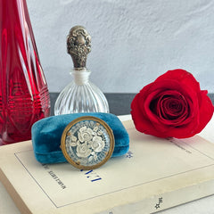 Vintage 1930s French round brooch with reverse carved Lucite floral center and gold tone metal frame, shown from various angles.