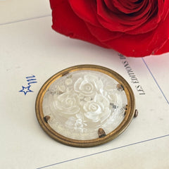 Vintage 1930s French round brooch with reverse carved Lucite floral center and gold tone metal frame, shown from various angles.