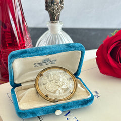 Vintage 1930s French round brooch with reverse carved Lucite floral center and gold tone metal frame, shown from various angles.