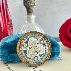 Vintage 1930s French round brooch with reverse carved Lucite floral center and gold tone metal frame, shown from various angles.