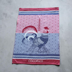 French jacquard cotton tea towel in blue, white, and red with rooster and Eiffel Tower motif and “Cocorico” lettering