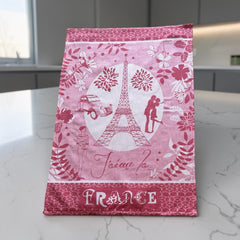 French jacquard cotton tea towel in red and white featuring the Eiffel Tower, romantic Paris couple, vintage car, and floral motifs with “J’aime la France” lettering.