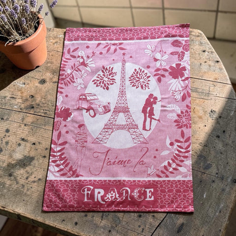 French jacquard cotton tea towel in red and white featuring the Eiffel Tower, romantic Paris couple, vintage car, and floral motifs with “J’aime la France” lettering.
