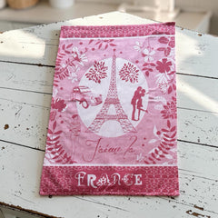 French jacquard cotton tea towel in red and white featuring the Eiffel Tower, romantic Paris couple, vintage car, and floral motifs with “J’aime la France” lettering.