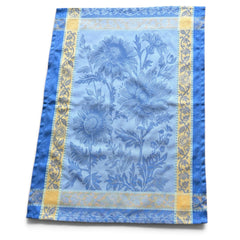 French jacquard cotton tea towel in sky blue and golden yellow featuring woven sunflower design and ornate border.