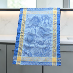 French jacquard cotton tea towel in sky blue and golden yellow featuring woven sunflower design and ornate border.