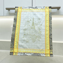 French jacquard cotton tea towel in green, yellow, and soft gray featuring a Le Vieux Chêne wine bottle surrounded by grapes and vine leaves.