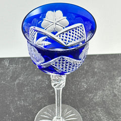 Vintage German cobalt blue cut crystal goblet with faceted stem, shown in excellent condition.