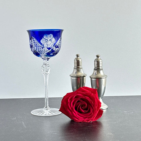 Vintage German cobalt blue cut crystal goblet with faceted stem, shown in excellent condition.
