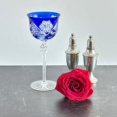 Vintage German cobalt blue cut crystal goblet with faceted stem, shown in excellent condition.