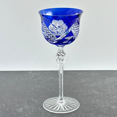 Vintage German cobalt blue cut crystal goblet with faceted stem, shown in excellent condition.