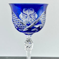 Vintage German cobalt blue cut crystal goblet with faceted stem, shown in excellent condition.
