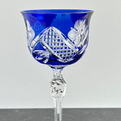 Vintage German cobalt blue cut crystal goblet with faceted stem, shown in excellent condition.
