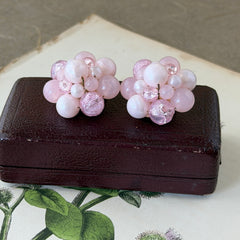 Vintage Germany light pink bead cluster clip‑on earrings with pearlized, crackled, and translucent beads in gold‑tone settings, signed Germany on the back.