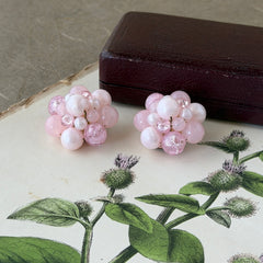 Vintage Germany light pink bead cluster clip‑on earrings with pearlized, crackled, and translucent beads in gold‑tone settings, signed Germany on the back.