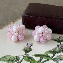 Vintage Germany light pink bead cluster clip‑on earrings with pearlized, crackled, and translucent beads in gold‑tone settings, signed Germany on the back.