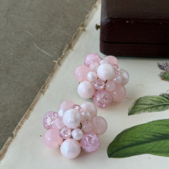 Vintage Germany light pink bead cluster clip‑on earrings with pearlized, crackled, and translucent beads in gold‑tone settings, signed Germany on the back.
