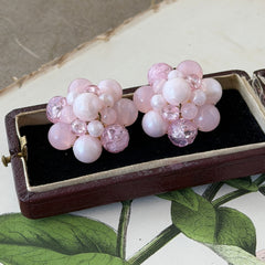 Vintage Germany light pink bead cluster clip‑on earrings with pearlized, crackled, and translucent beads in gold‑tone settings, signed Germany on the back.