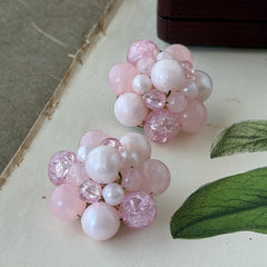 Vintage Germany light pink bead cluster clip‑on earrings with pearlized, crackled, and translucent beads in gold‑tone settings, signed Germany on the back.
