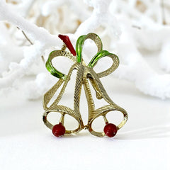 Vintage Gerry’s Christmas bells brooch in gold tone metal with red and green enamel ribbon, signed on back, festive mid-century holiday jewelry.