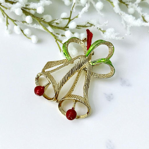 Vintage Gerry’s Christmas bells brooch in gold tone metal with red and green enamel ribbon, signed on back, festive mid-century holiday jewelry.