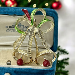 Vintage Gerry’s Christmas bells brooch in gold tone metal with red and green enamel ribbon, signed on back, festive mid-century holiday jewelry.