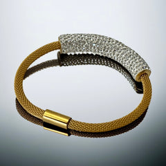 Gold tone mesh bracelet with a curved white centerpiece set with clear rhinestones over silver foil backing, creating a bright silvery shimmer; finished with a magnetic clasp and sleek modern design.