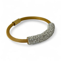 Gold tone mesh bracelet with a curved white centerpiece set with clear rhinestones over silver foil backing, creating a bright silvery shimmer; finished with a magnetic clasp and sleek modern design.