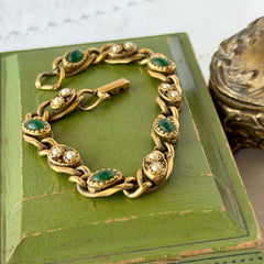 Vintage Goldette N.Y. bracelet with alternating green cabochons and faux pearls in textured gold‑tone curb links, fold‑over clasp signed Goldette N.Y.