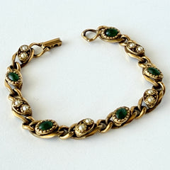 Vintage Goldette N.Y. bracelet with alternating green cabochons and faux pearls in textured gold‑tone curb links, fold‑over clasp signed Goldette N.Y.
