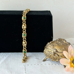 Vintage Goldette N.Y. bracelet with alternating green cabochons and faux pearls in textured gold‑tone curb links, fold‑over clasp signed Goldette N.Y.